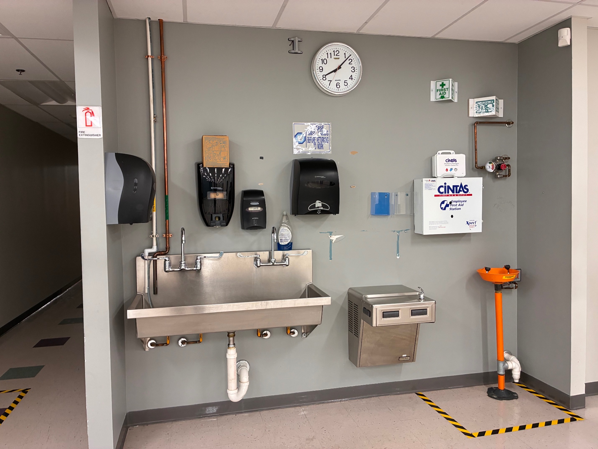 Before refresh photo of a utility and sink area under construction