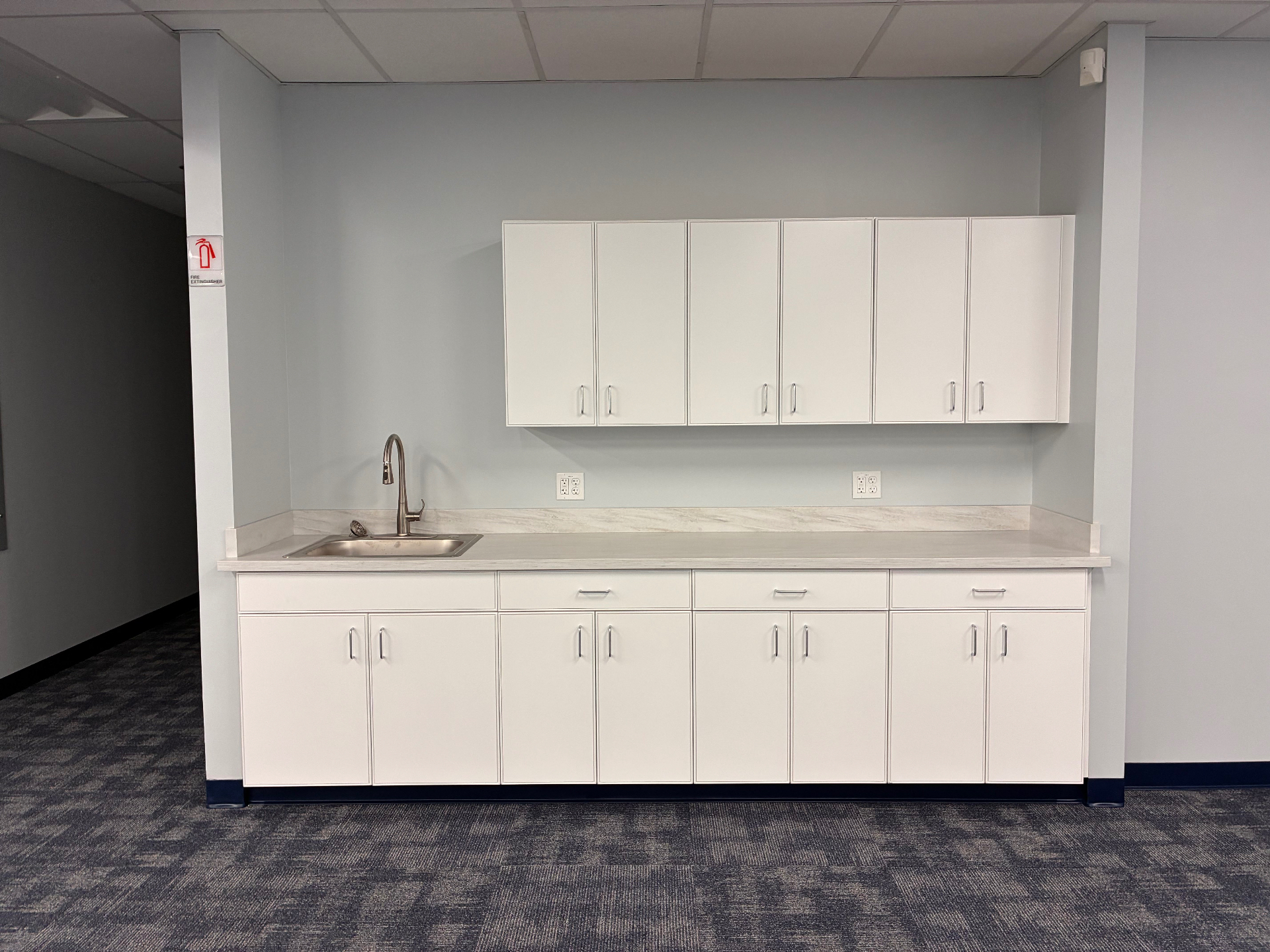 After refresh photo of a completed utility area with finished cabinetry and surfaces